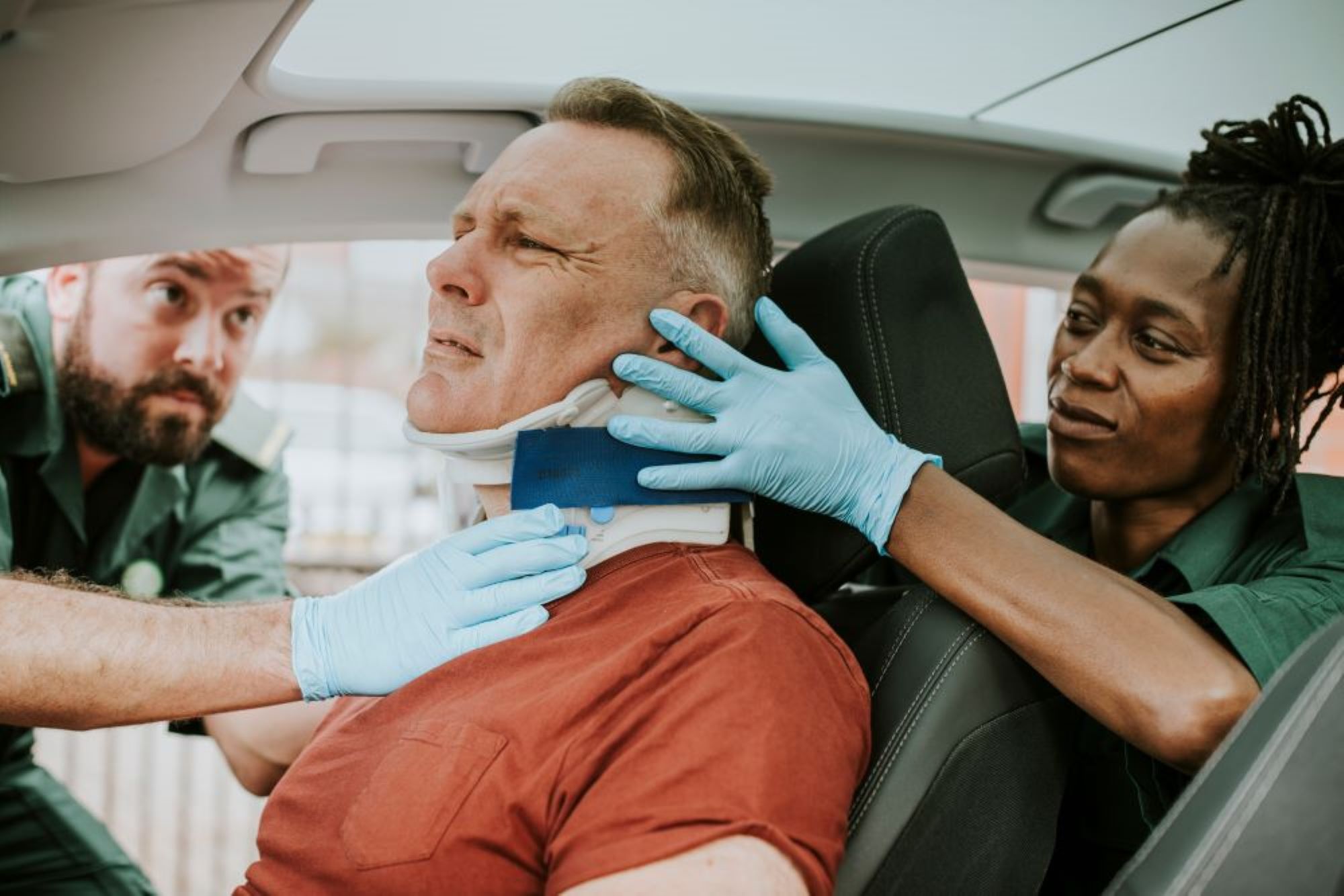man with neck brace in car